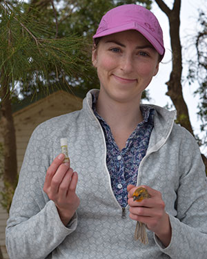 Headshot of Olivia Smith outdoors in a pink hat