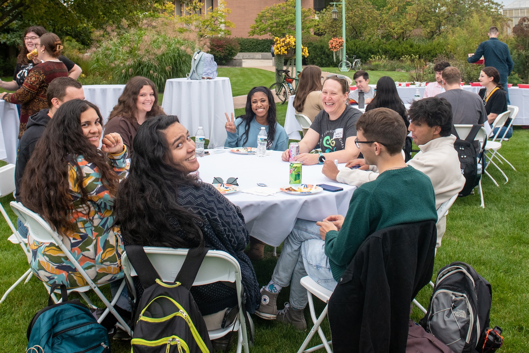Envision EEB participants sit at a table during an outdoor reception