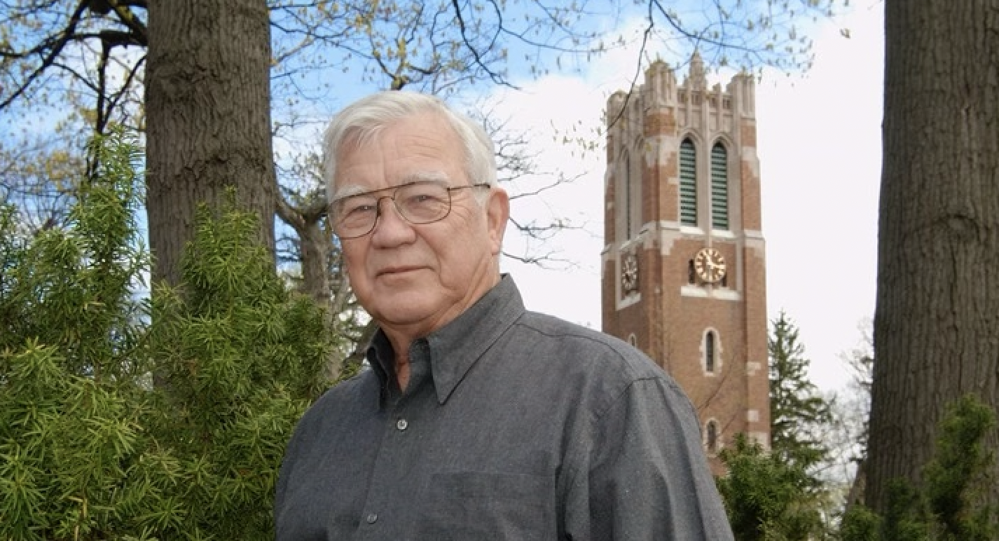 Guy Bush standing with the MSU carillon in the background