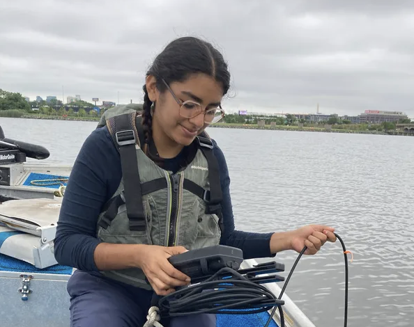 Jessica Diaz Vázquez monitoring lake water from a boat