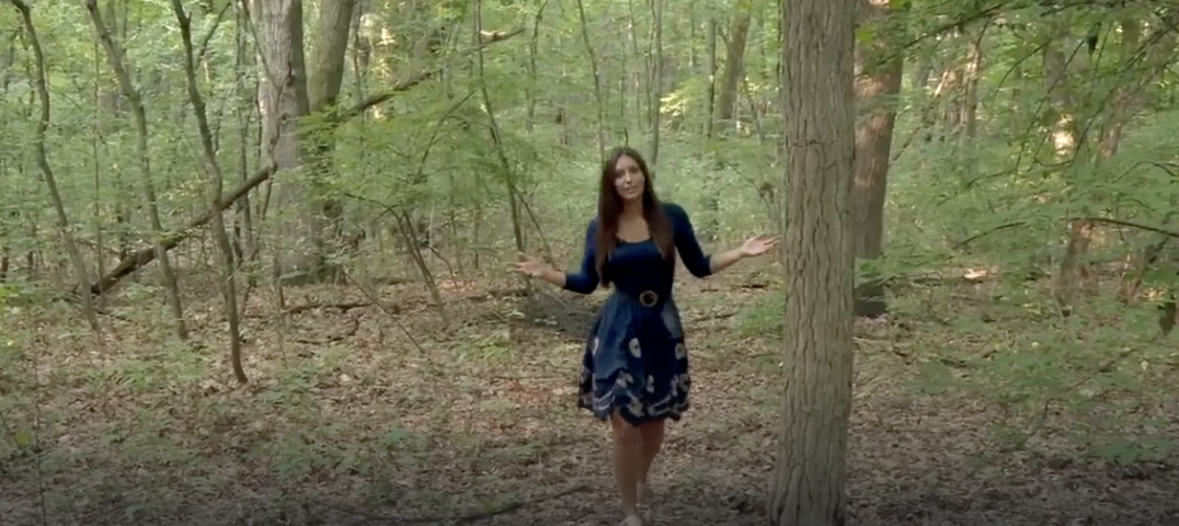 News reporter talks in a forest